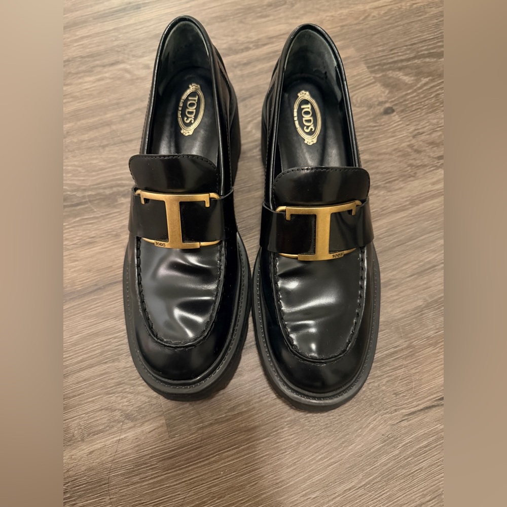 Tod's Shiny Black Loafers with Gold Accent